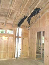 Ventilation ducts through the ceiling and continuing down to the floor below